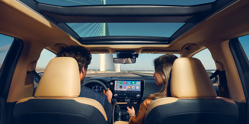 Interior view of a car showing two passengers in the back seat and the dashboard, highlighting premium materials in El Paso, TX.