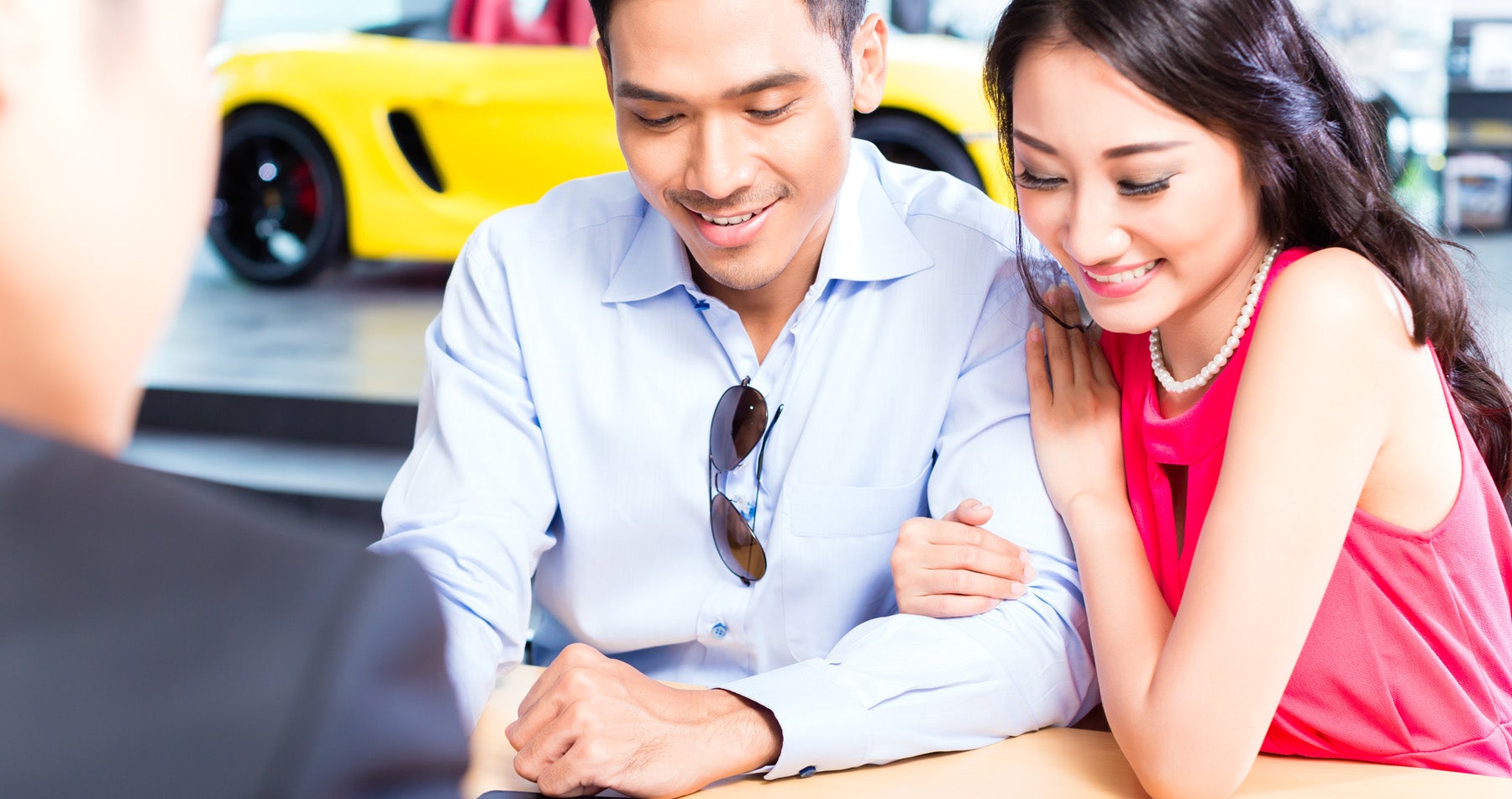 couple with salesman at desk
